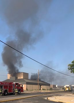 The theater building at the former campus of Adams City High School catches fire July 15.